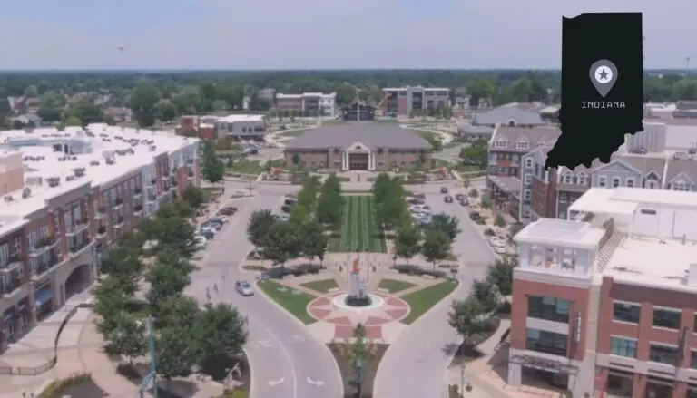 A vibrant aerial view of Greenwood, Indiana, showcasing its central plaza, surrounding buildings, and green spaces