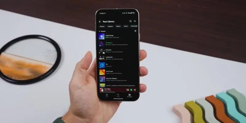  A hand holding a smartphone with the Spotify app open