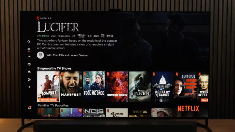 A smart TV screen displaying Netflix’s interface with a selection of popular TV shows and movies