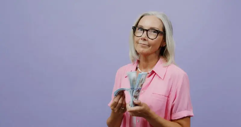 A woman is holding a bundle of money in her hands