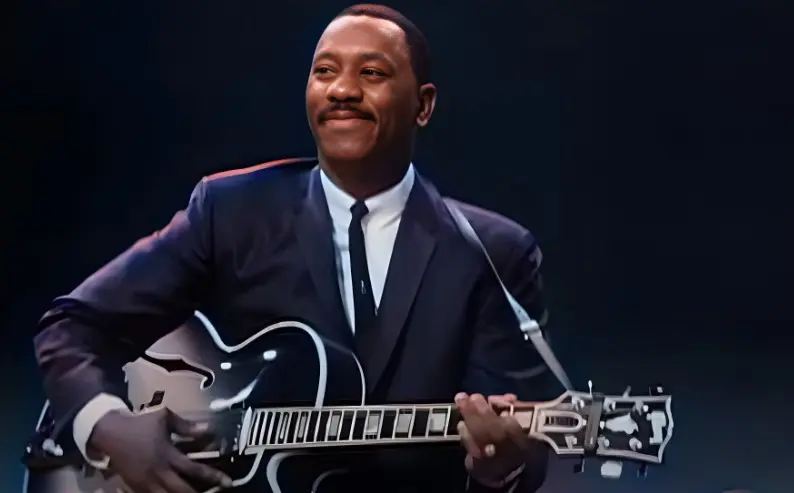 Wes Montgomery playing a guitar